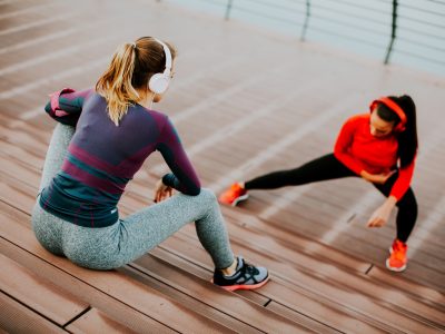 Young woman exercising with a personal trainer outside Young woman exercising with a personal trainer outside